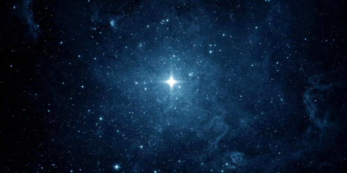 Vast blue starfield with bright stars and nebulae scattered throughout the cosmos