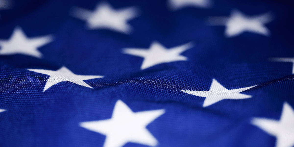 Close-up of a blue fabric with white stars, resembling a flag pattern