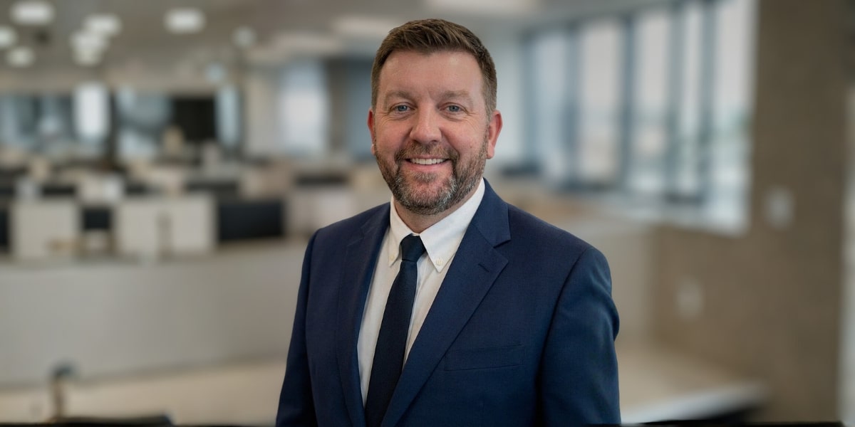 Scott Buchanan, CEO of CoreLabs AI, stands confidently in a professional setting, exemplifying leadership in AI transformation.