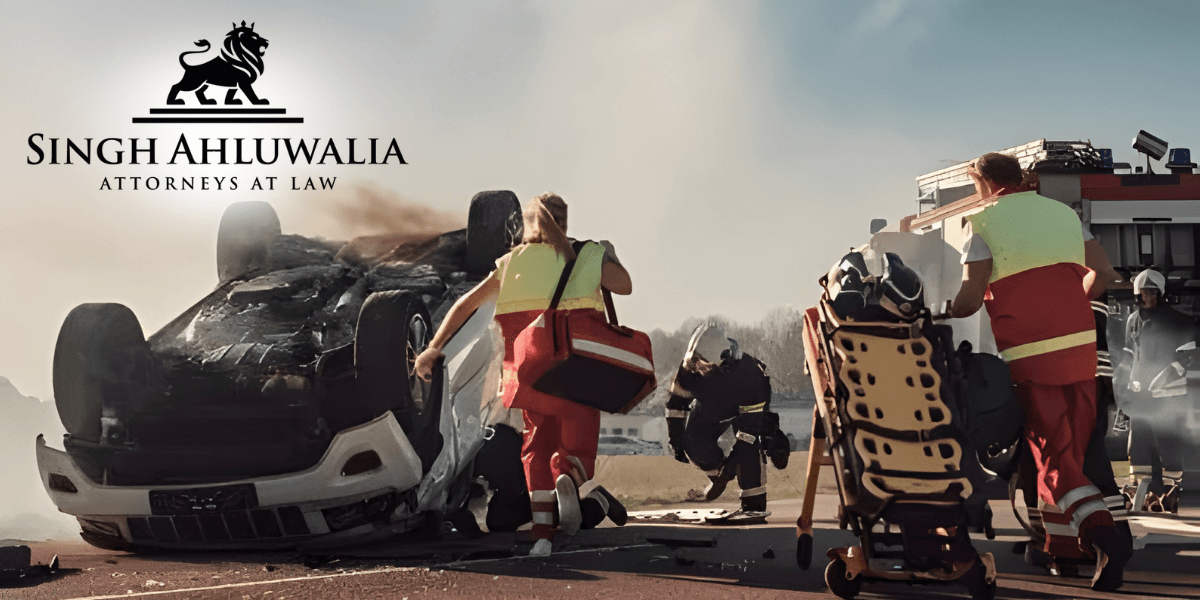 Emergency responders assist at a car accident scene, with Singh Ahluwalia Attorneys at Law logo, offering legal support