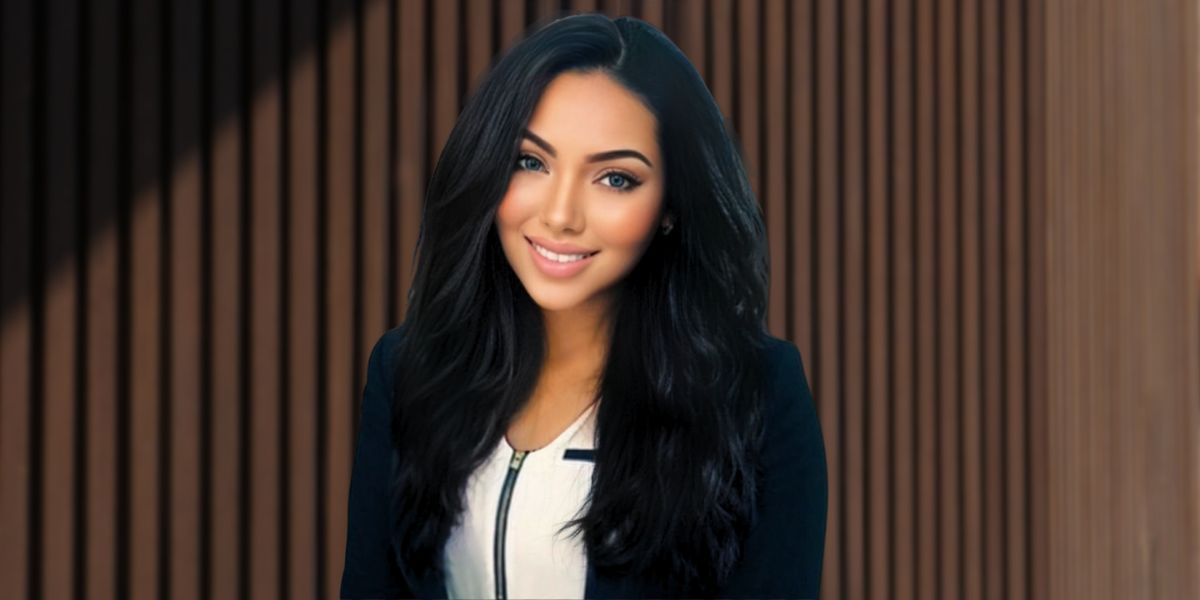 Portrait of a confident woman in a business suit, smiling with long black hair, standing in front of a brown wooden wall, conveying professionalism and elegance.