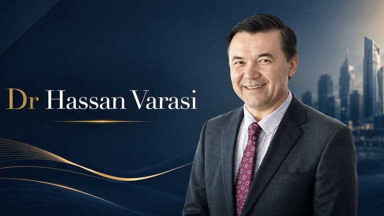 Portrait of Dr. Hassan Varasi in business attire beside city skyline, promoting leadership and customer experience in business.