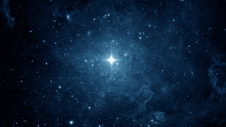 Vast blue starfield with bright stars and nebulae scattered throughout the cosmos