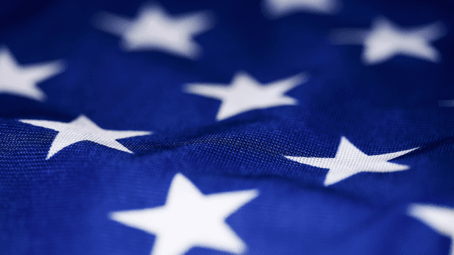 Close-up of a blue fabric with white stars, resembling a flag pattern
