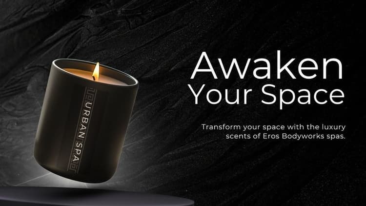 Image of Eros Bodyworks Signature Candle featuring a sleek black container with a lit wick, promoting luxury fragrances for transforming spaces.