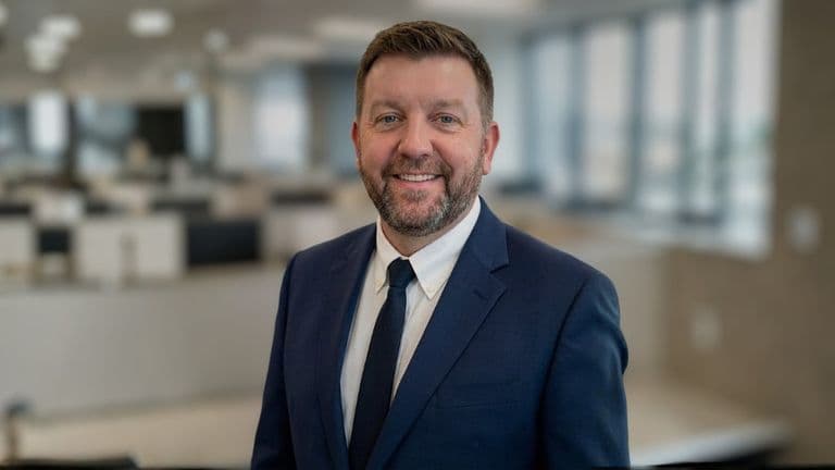 Scott Buchanan, CEO of CoreLabs AI, stands confidently in a professional setting, exemplifying leadership in AI transformation.