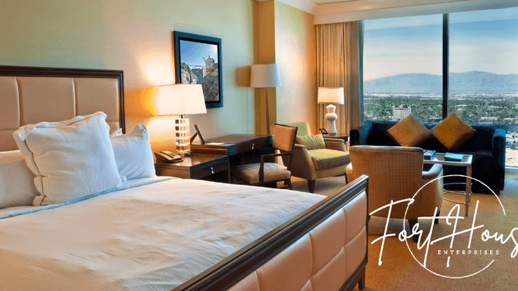 Modern hotel-style office suite with city and mountain view, representing Fort House Enterprises’ stability and trusted business lending solutions.