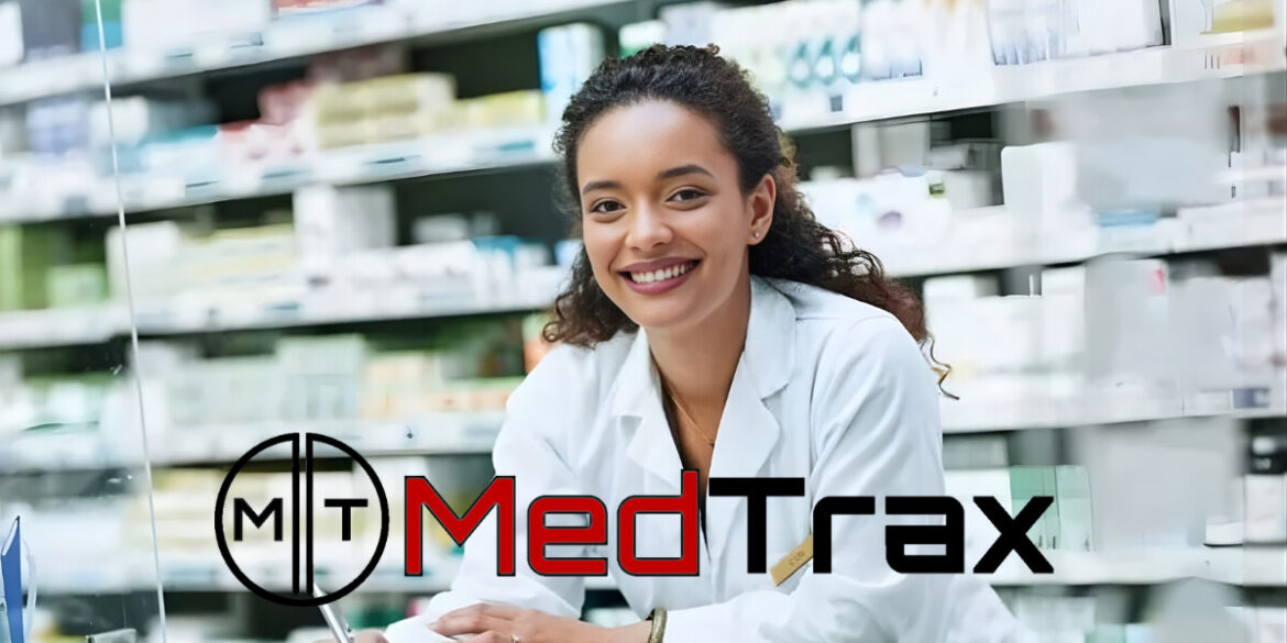 Smiling pharmacist in a white coat at a pharmacy counter with shelves of medications, MedTrax logo overlayed."
