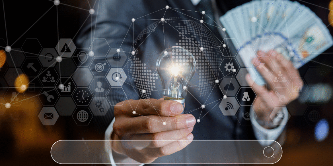 Businessperson holding a light bulb and cash with digital finance and technology icons overlay.